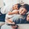 father with two sons laying down on the couch